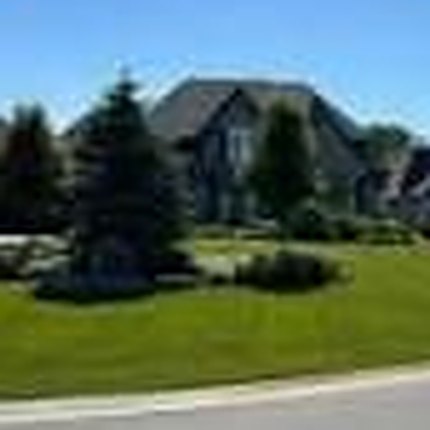Manicured lawn and evergreen garden bed, lawn maintenance by Wrobel Landscaping